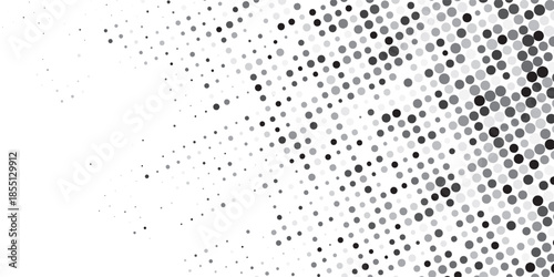 Dynamic monochrome halftone dot pattern creating a fading gradient abstract background for modern design