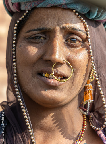 expressive face of indian woman daily wage worker at construction site in traditional attire