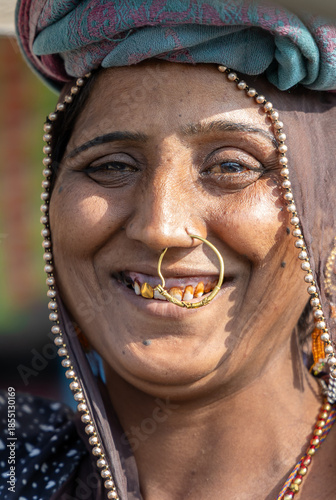 rural tribal woman smiling face with gold nose ring in ethnic traditional attire