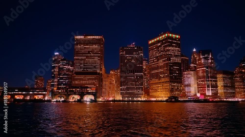 Golden illumination of New York, USA at night. Travel by the boat along the Staten Island ferry boat terminal.