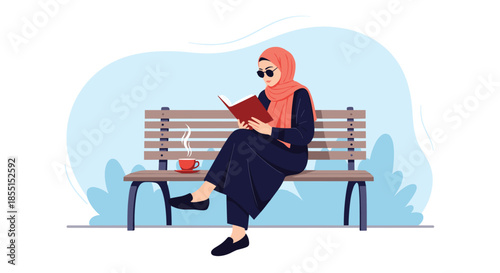 Young woman wearing a hijab and sunglasses sitting on a park bench and reading a book while enjoying a hot cup of coffee.