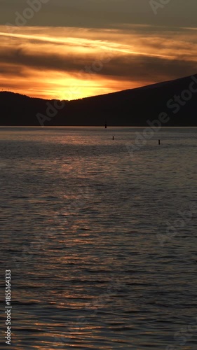 English Bay Sunset Swim Vancouver vertical video 4K UHD.A swimmer at sunset on English Bay. Vancouver, British Columbia, Canada. 4K, UHD. Vertical video.
