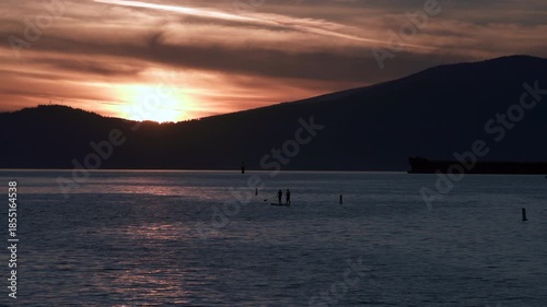 English Bay Paddle Boarding Vancouver 4K UHD.Sunset paddle boarders on English Bay. Vancouver, British Columbia, Canada. 4K, UHD.
