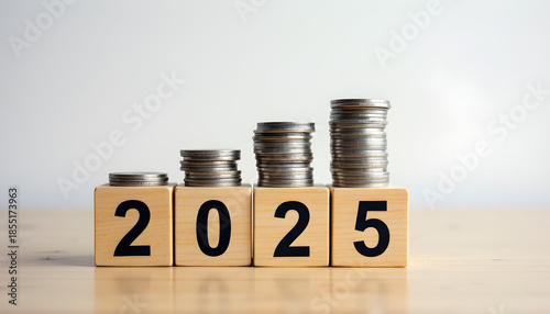 Wallpaper Mural Wooden cubes forming year 2025 with stack of growth coins symbolizing financial annual plan, savings, budget, investment and New Year resolution concept Torontodigital.ca