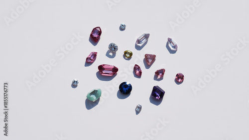 Collection of Assorted Faceted Gemstones Scattered on a White Background