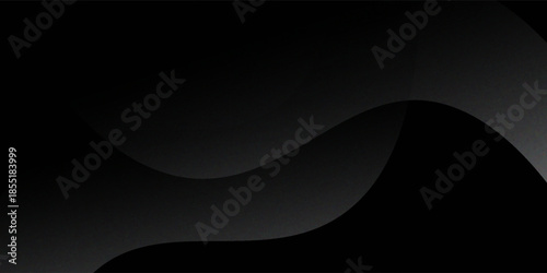 Sandblasted or brushed titanium or steel metal surface, the light reflection of the curved lines creates a smooth gradation on the dark black metallic background