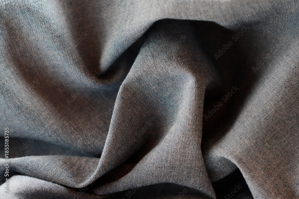Fototapeta premium Dramatic lighting on denim fabric. Background, wallpaper.