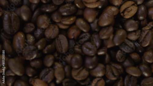 Roasted Coffee Beans With Swirling White Smoke on Black Background Copy Space 