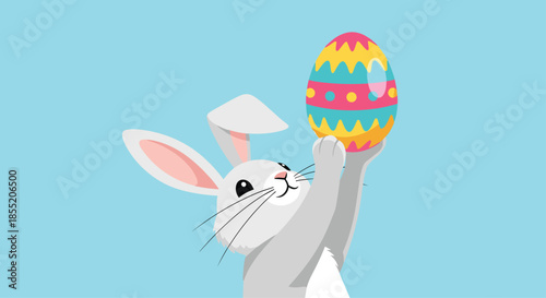 Adorable gray Easter bunny character joyfully holding up a beautifully decorated colorful egg against a soft light blue background.