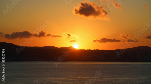 Mykonos sunset panorama with few clouds