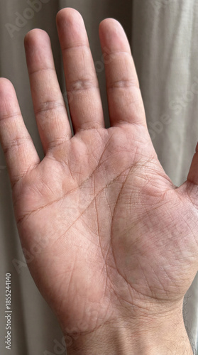 Closeup hand palm shows skin lines. Hand texture and hand gesture for World Hand Hygiene Day, healthcare safety posters, hand washing reminder, clean skin concept, neutral background