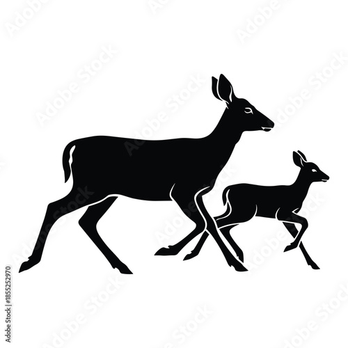 Silhouette of a mother deer and her fawn walking together