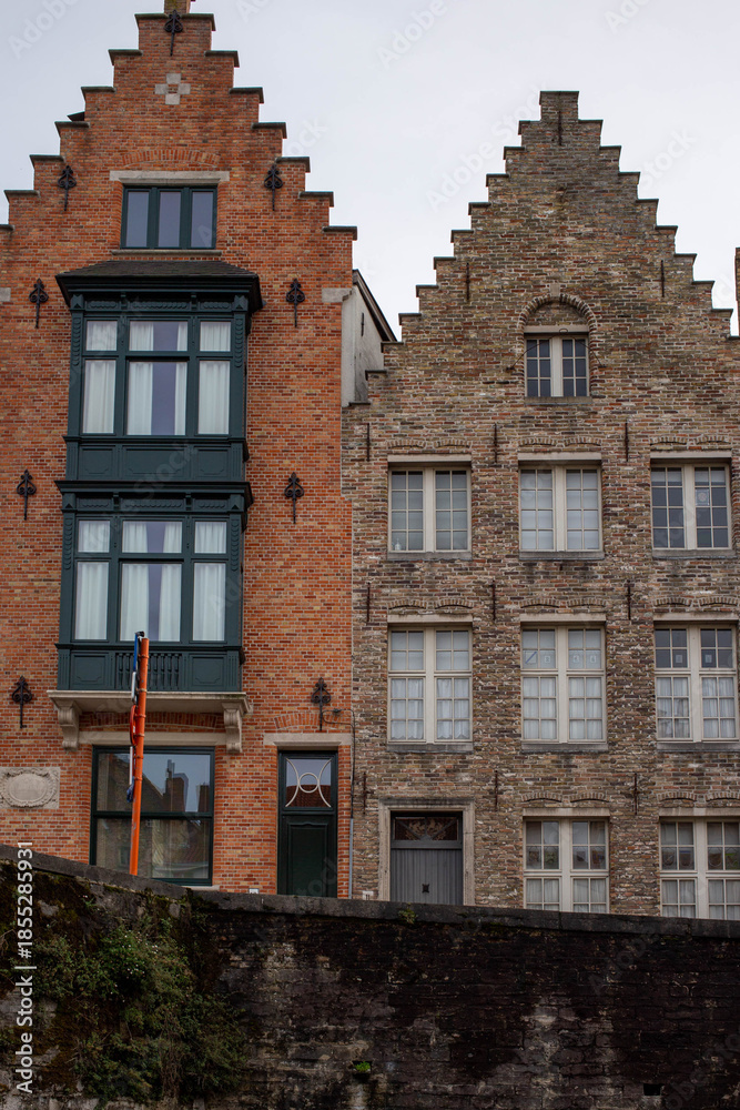 Naklejka premium Bruges (Brugge), Belgium - October 17, 2022. Historical architecture on the streets of Bruges, Belgium. Cityscape of Bruges.