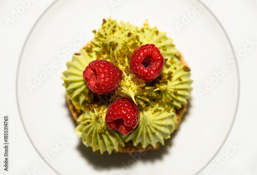 Pistachio tart with raspberries on a plate