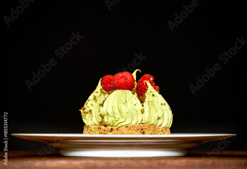 Pistachio tart with raspberries on a plate