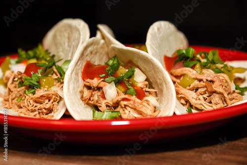 Shredded pork street tacos with onion, salsa and cilantro