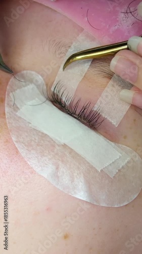 eyelash extensions process includes applying individual lashes with precision by experienced artist for glamorous luxurious look. Professional, delicate application enhanced eye beauty. 4k