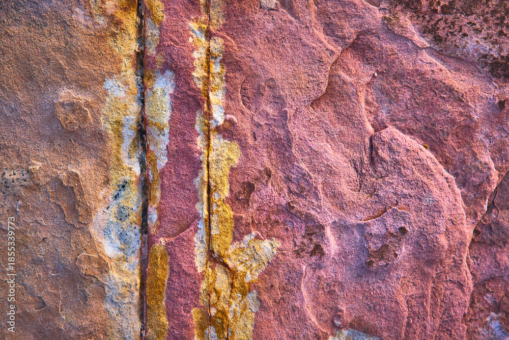 Naklejka premium Colorful Rock Texture Close Up with Mineral Patterns and Weathered Surface
