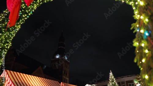 Festive evening fair, Evening holiday bazaar illuminated by colorful lights and textured reflections slow motion