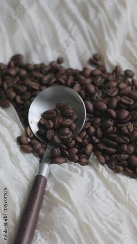 Close-Up of Coffee Beans on Fabric with Rustic Spoon