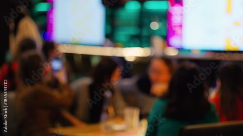 Spectators observe live multimedia display, Crowd viewing colorful LED broadcast in relaxed setting slow motion