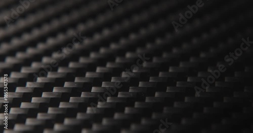 Close-up slide over the real carbon fiber texture background. 