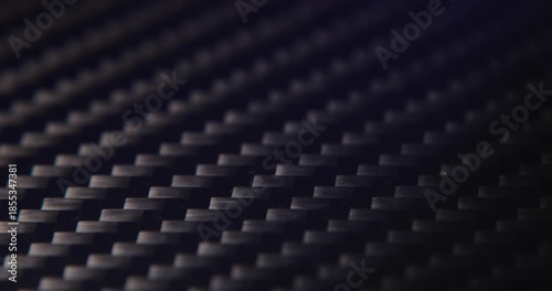 Close-up slide over the real carbon fiber texture background. 