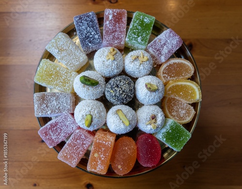 Table of New Year Sweets. Lunar New Year 2026 (Year of the Horse). Variety of colorful traditional Lunar New Year sweets, candied fruits, and pastries, arranged neatly on a decorative, circular tray.
