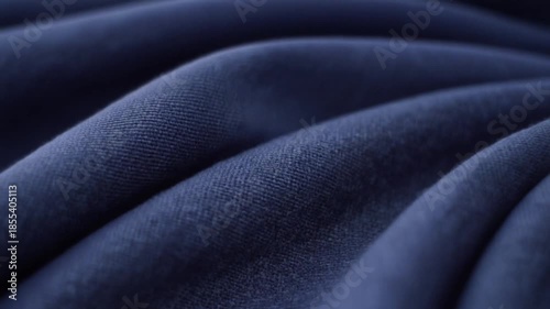 closeup blue fabric folds moving in slow motion with detail textile texture