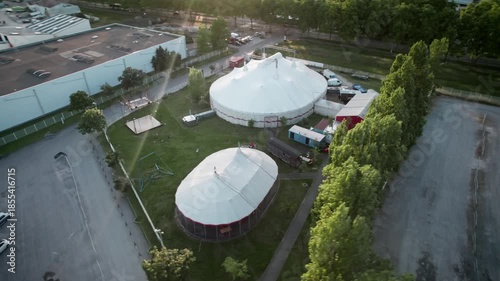 Wallpaper Mural A circus tent is set up in a field with a large building in the background. With drone movement, panoramical in the sunset. Bordeaux, France. Torontodigital.ca