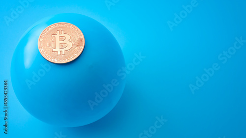 Crypto currency bubble, hazardous trading and  stock exchange crisis concept with bitcoin and balloon about to burst isolated on blue background with copy space