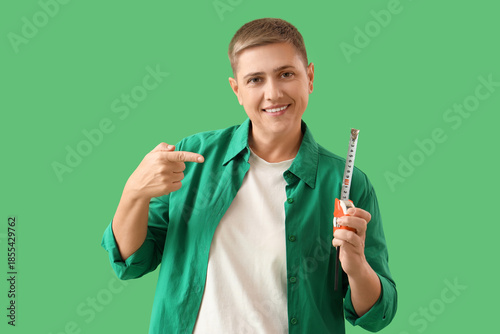 Young woman pointing at tap...
