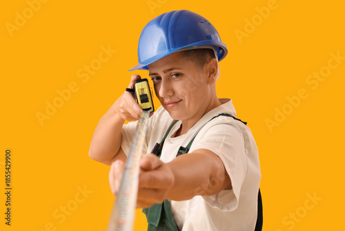 Female worker with tape mea...