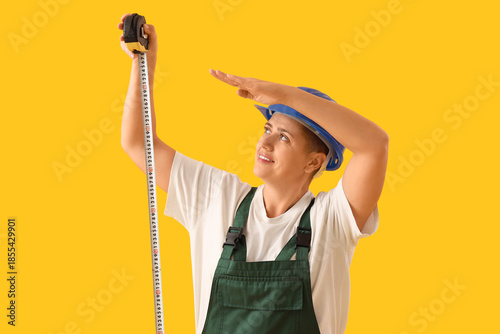 Female worker with tape mea...