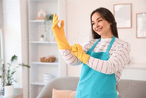 Female janitor putting on r...