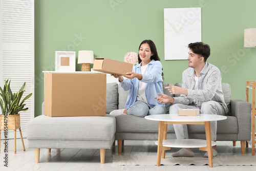 Young couple with parcel bo...