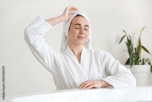 Young woman in soft bathrob...