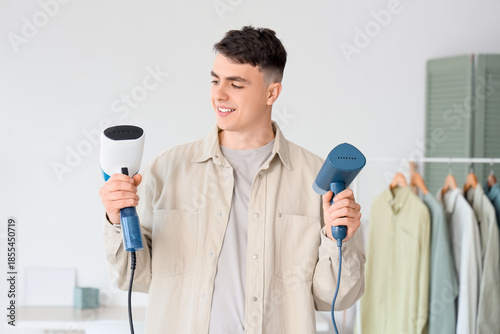 Young man with steamers for...