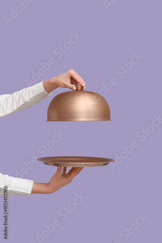 Hands of waitress with meta...
