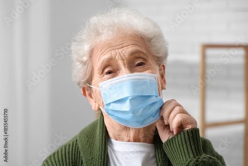 Elderly woman in medical ma...