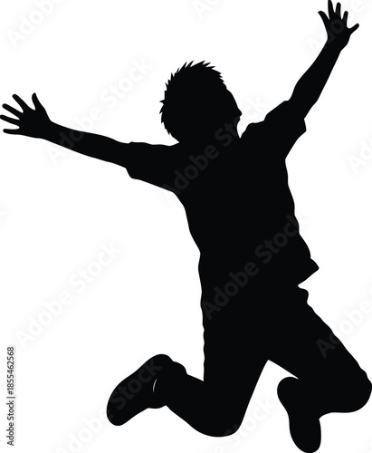 Silhouette of a young man jumping high in the air with arms raised in a gesture of pure excitement and freedom