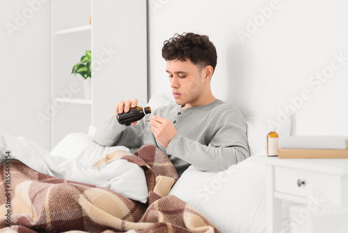 Ill young man pouring cough...