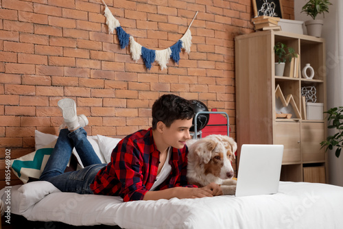 Teenage boy with modern lap...