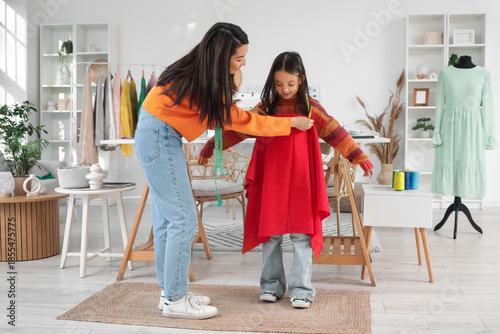 Happy Asian mother taking d...