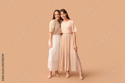 Happy young twin sisters on...