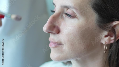 Beauty Routine Professional Makeup Applying Foundation Brush to Young Womans Jawline