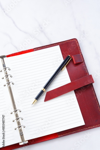 Wallpaper Mural Opened schedule planner, diary, notebook on white table
 Torontodigital.ca