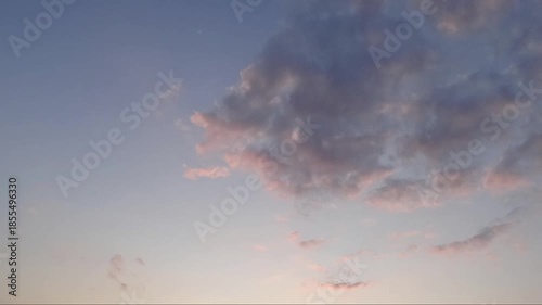 Time lapse of clouds formation with sunset light background