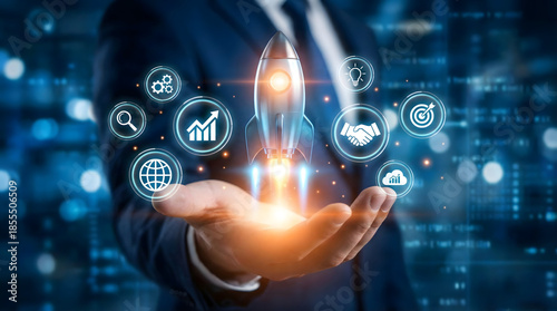 Bild auf Leinwand Businessman,launching,a,digital,rocket,from,his,hand,surrounded,by,innovation,and,growth,symbols,visualizing,successful,startup,launch,business,expansion,and,attaining,ambitious,corporate,goals
