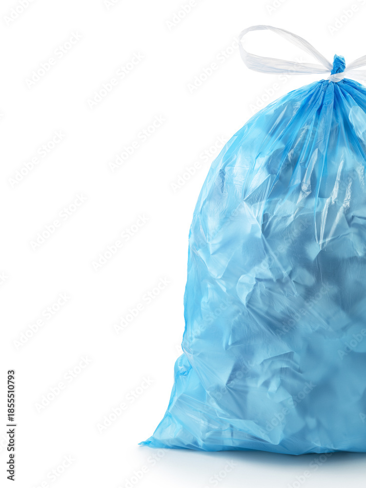 Fototapeta premium Close-up. A blue plastic bag with a white handle on a white background on the side. The bag is full of garbage.Advertisement